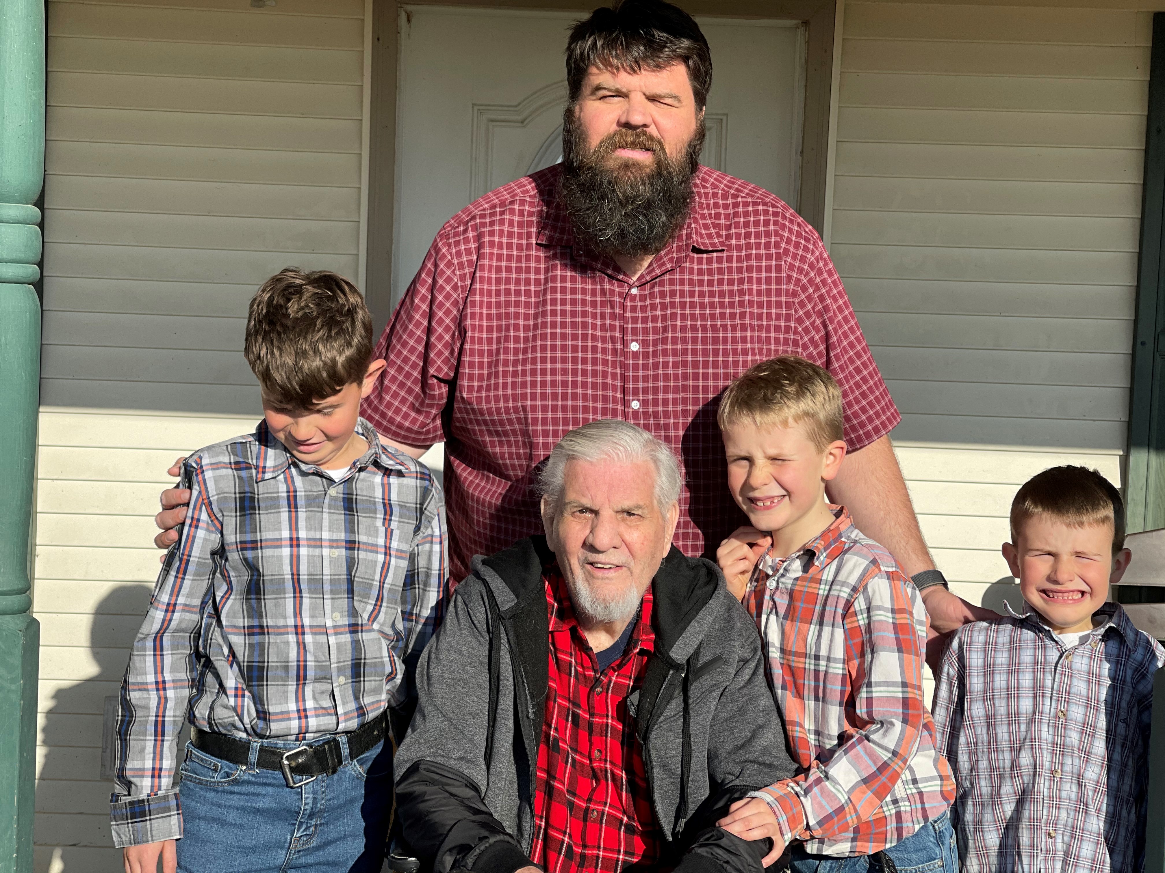 Dad, his father, and the three boys on the porch